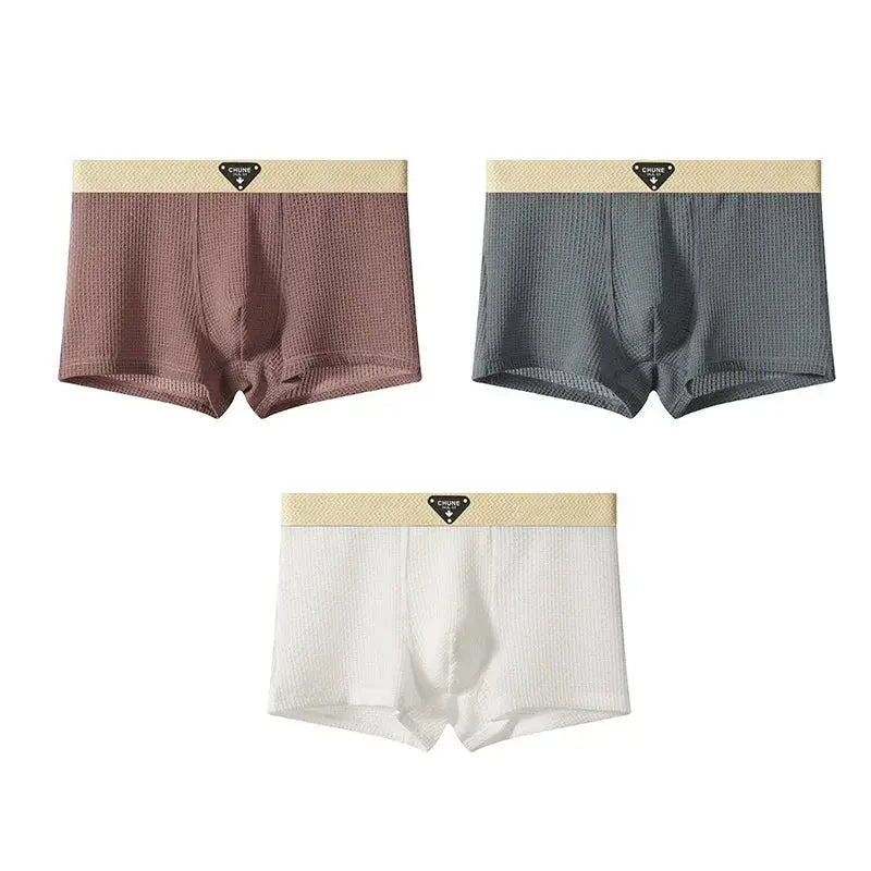Simples Market 3-pack men's satin-like boxer shorts in brown, gray, and white with beige elastic waistband.