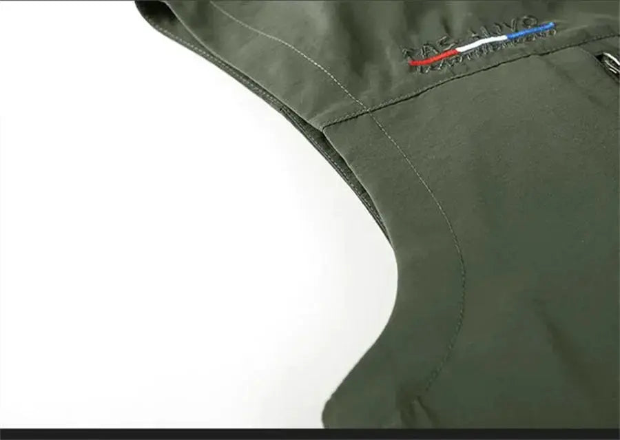 Sleeveless olive-green outdoor vest with stitching details at the armhole