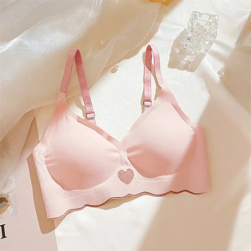 Pink push-up bra with heart center detail, adjustable straps, seamless wireless design by Simples Market.