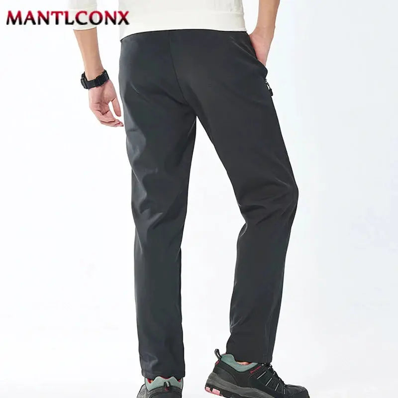 Breathable men's black jogger pants with elastic waist and straight fit; MANTLCONX logo visible