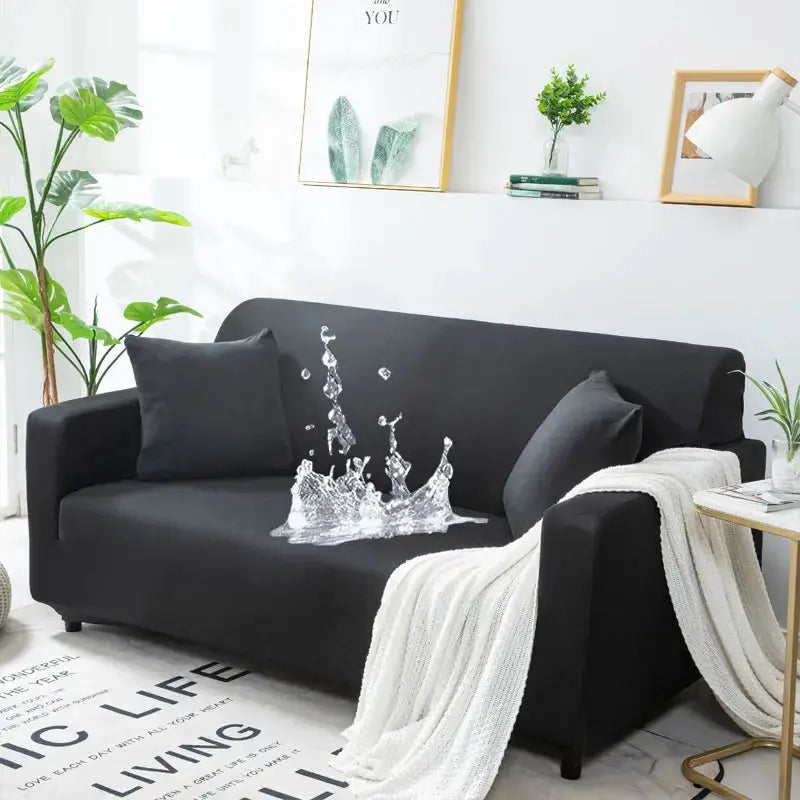 Waterproof stretch sofa cover on black couch with matching cushions