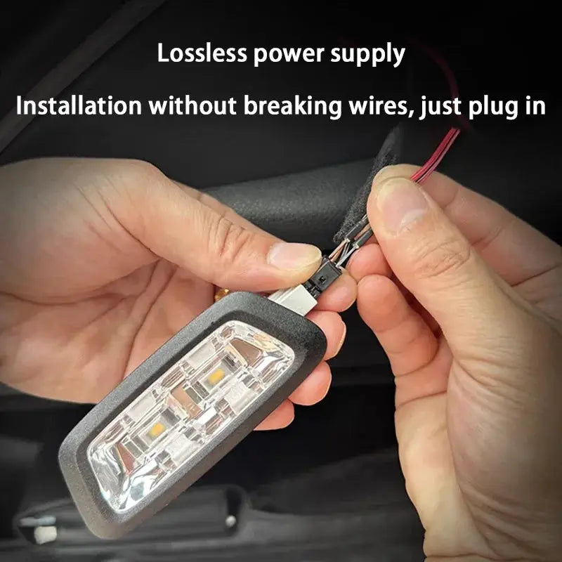Car trunk LED light strip with black housing and clear lens, installation in progress