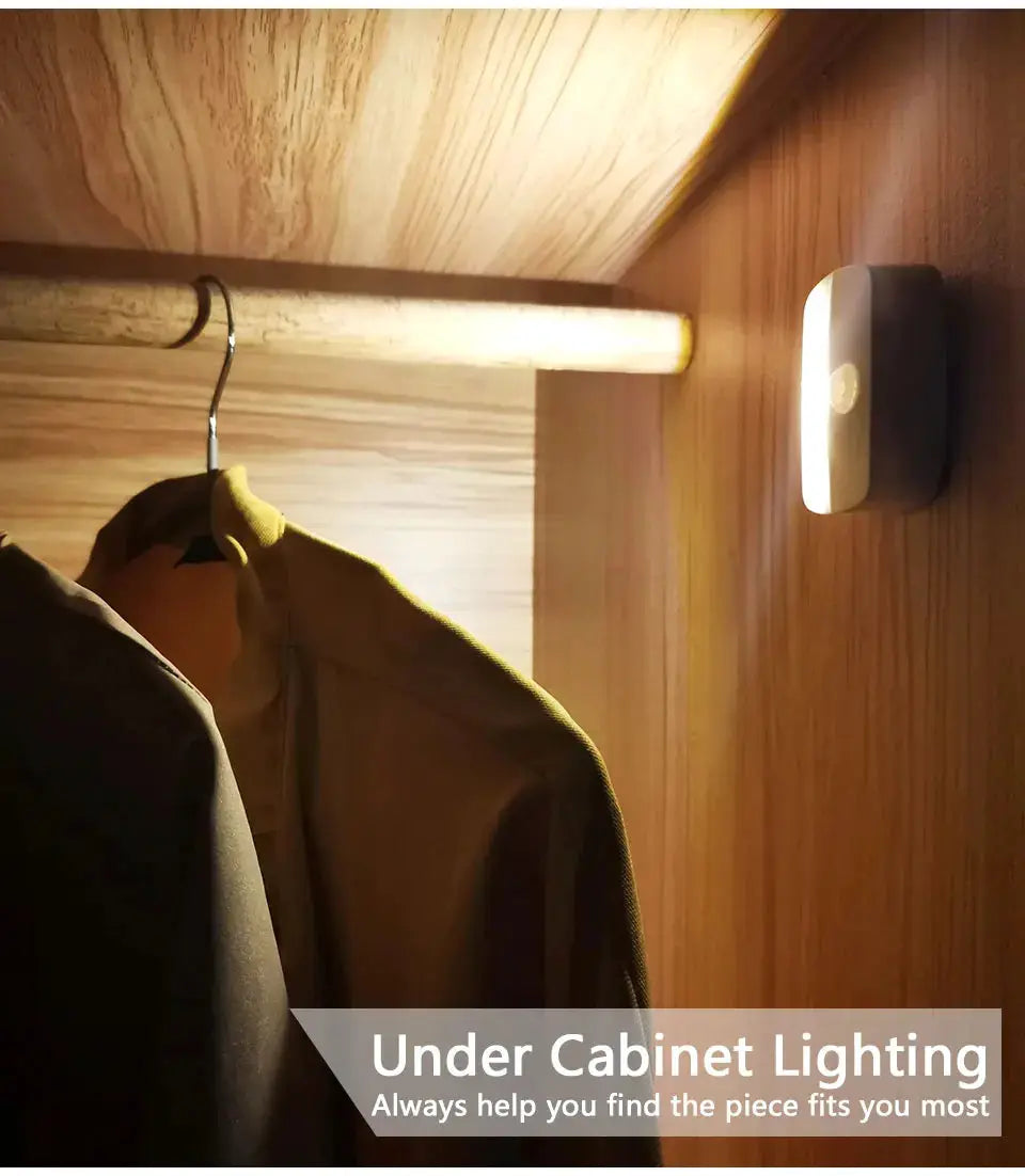 Wireless LED motion-sensor night light, plug-in, white, mounted in a wooden closet.