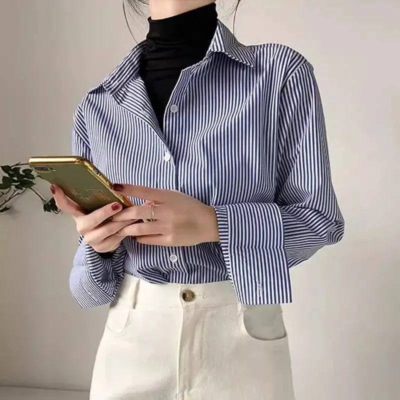Blue and white striped loose women's blouse with long lantern sleeves and stand collar.