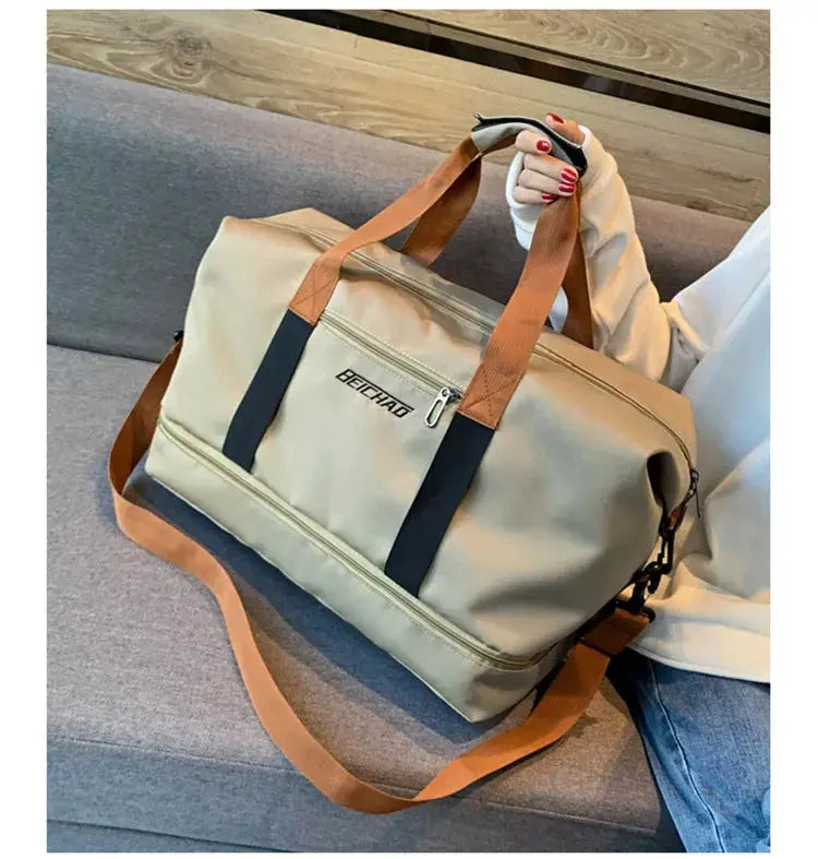 Travel gym bag by BEICHAD in beige with tan handles, navy side straps, zip pocket, and adjustable shoulder strap.