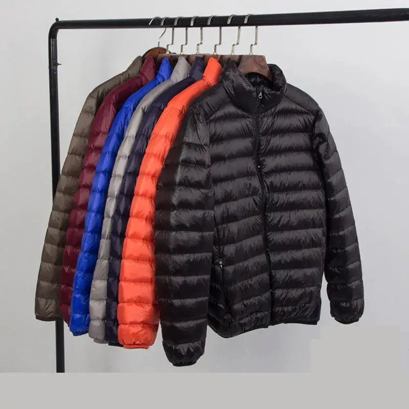 Simples Market men's hooded down jacket; ultra-light black front coat among a rack of several colorful puffer jackets