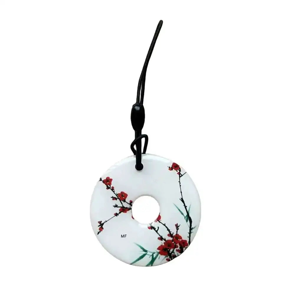 RFID key tag: circular white disk with red blossom design and central hole, attached to black lanyard