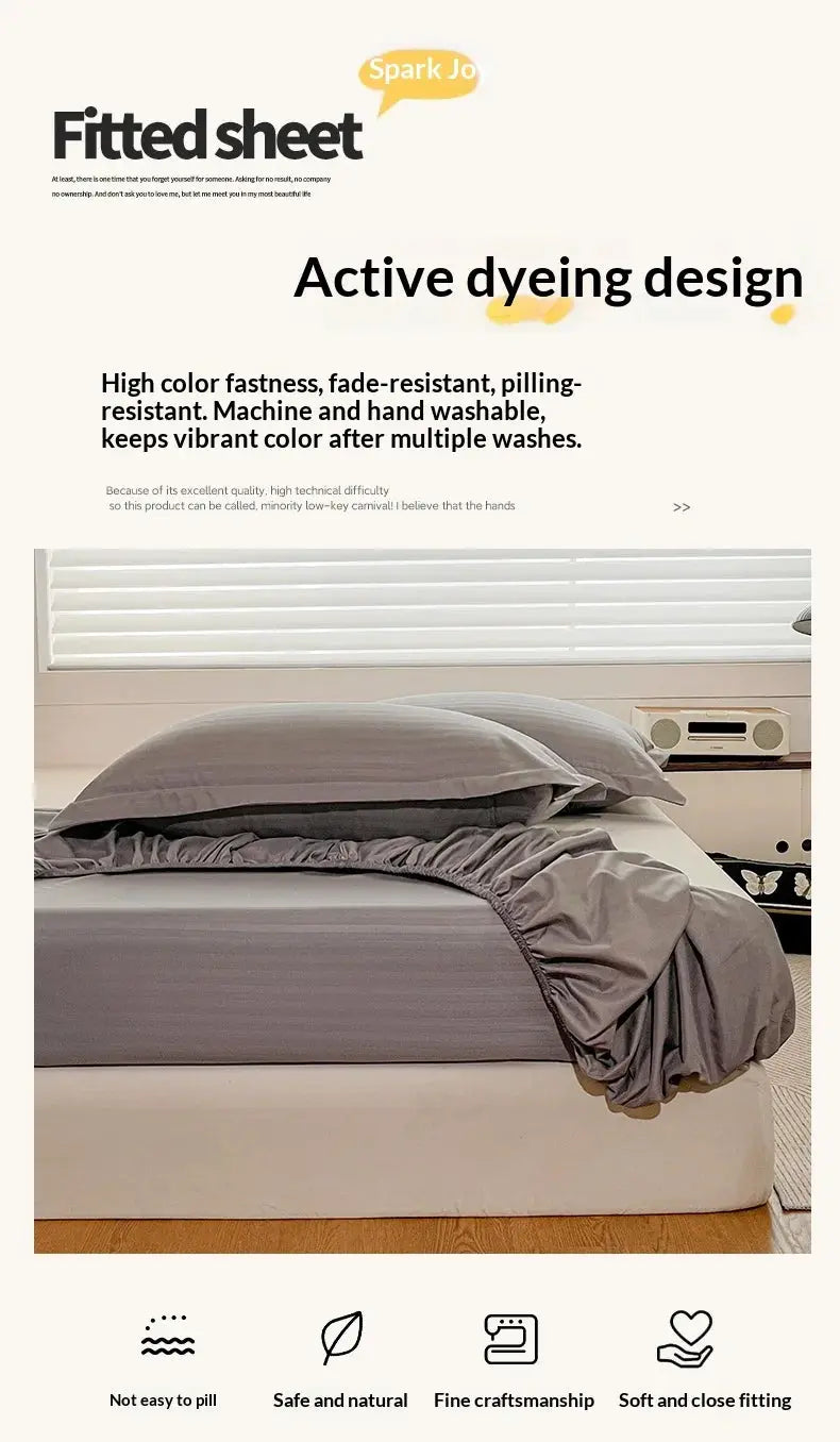 Simples Market fitted sheet with elastic edge in solid gray on a bed