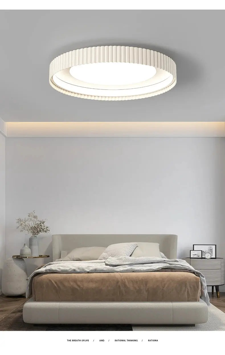 Modern round LED ceiling light by Simples Market, white ribbed metal fixture for bedroom.