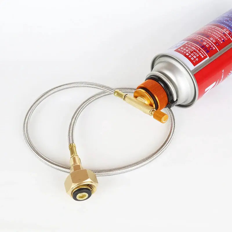 Simples Market camping gas refill adapter with stainless steel hose and brass fittings attached to red gas canister