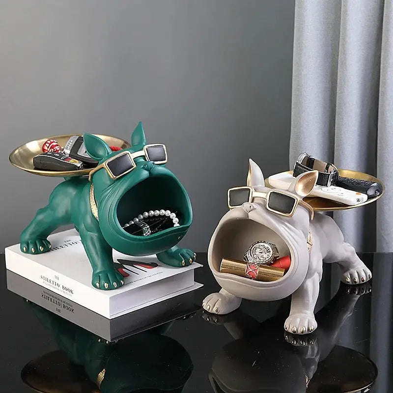 Resin bulldog statue storage-tray duo in green and beige with gold-framed sunglasses, home decor