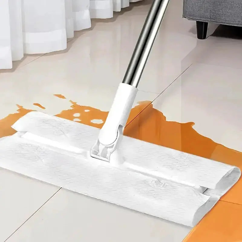 White disposable dust-removal mop pad attached to a metal-handled electrostatic mop on tiled floor