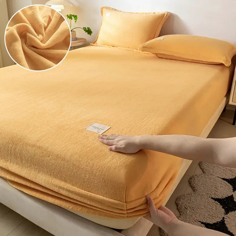 Velvet thermal mattress cover by Simples Market in peach, plush fabric texture on bed, 120x200