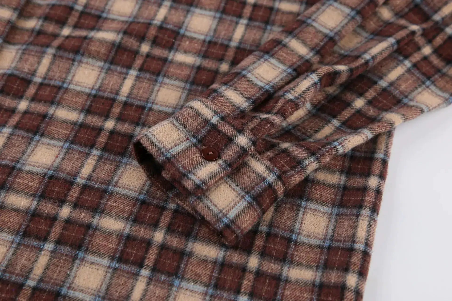 Women's long-sleeve vintage plaid shirt close-up; brown, beige and blue check pattern.