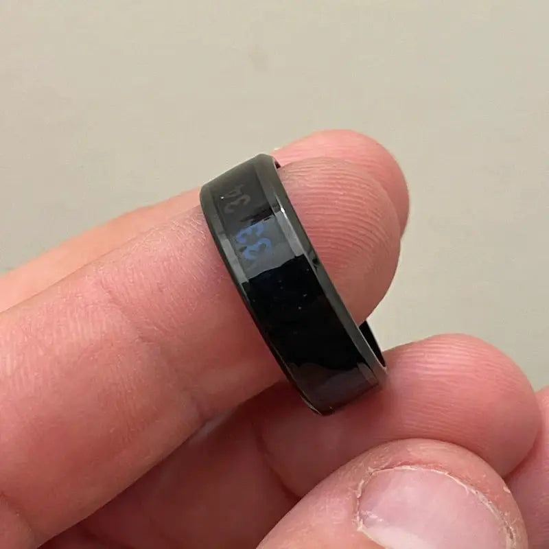 Smart stainless steel ring with black coating and digital display.