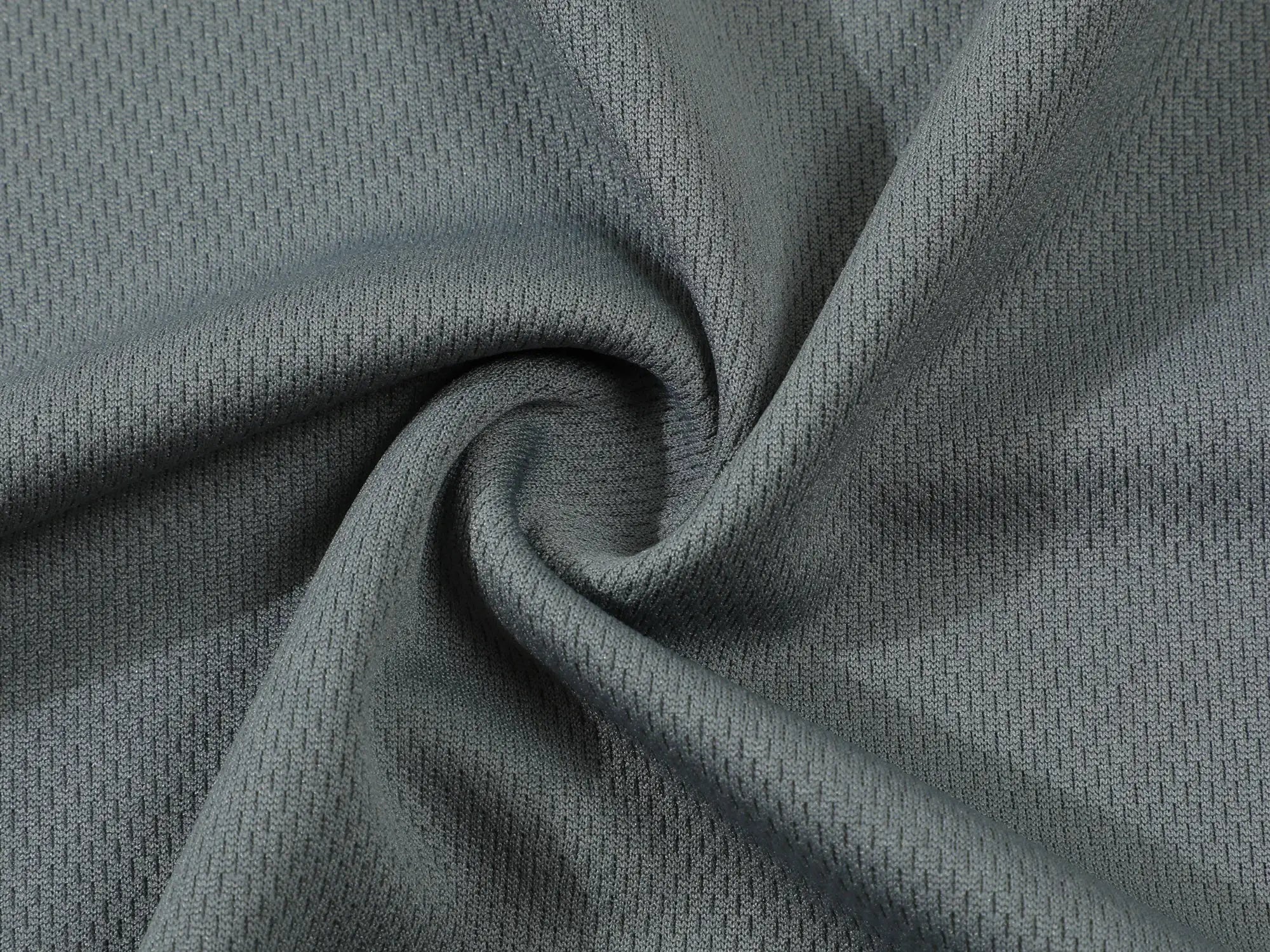 Polo shirt fabric close-up in grey; ultra-light, breathable knit texture.