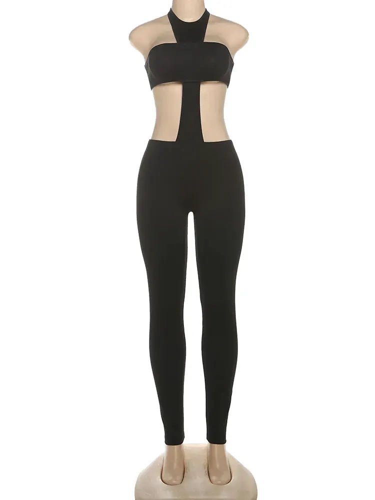 Kliou cross-cut halter jumpsuit by Simples Market; black backless elastic bandage one-piece with side cutouts.