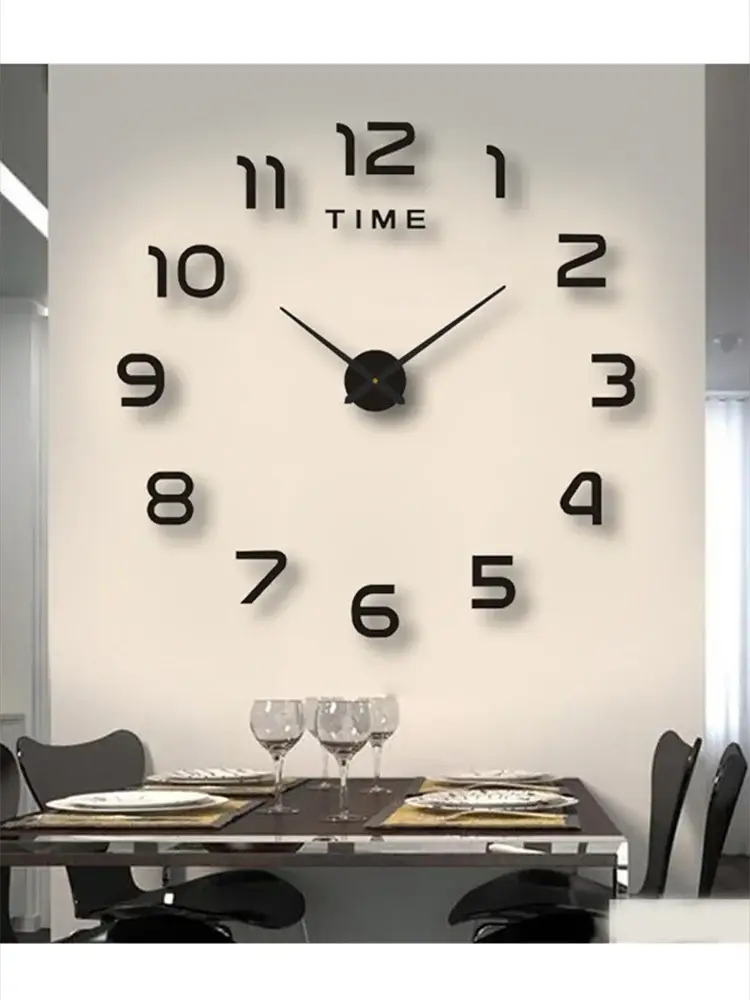 Large modern wall clock with oversized black numerals and central hands on a white wall above a dining table set with glassware
