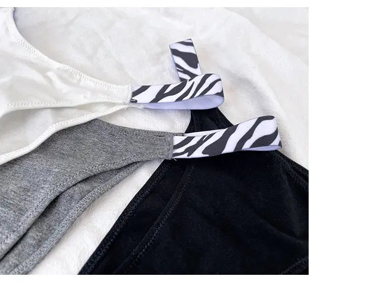 Three pairs of girls satin briefs with zebra-striped elastic waistbands in white, gray, and black (3-pack)