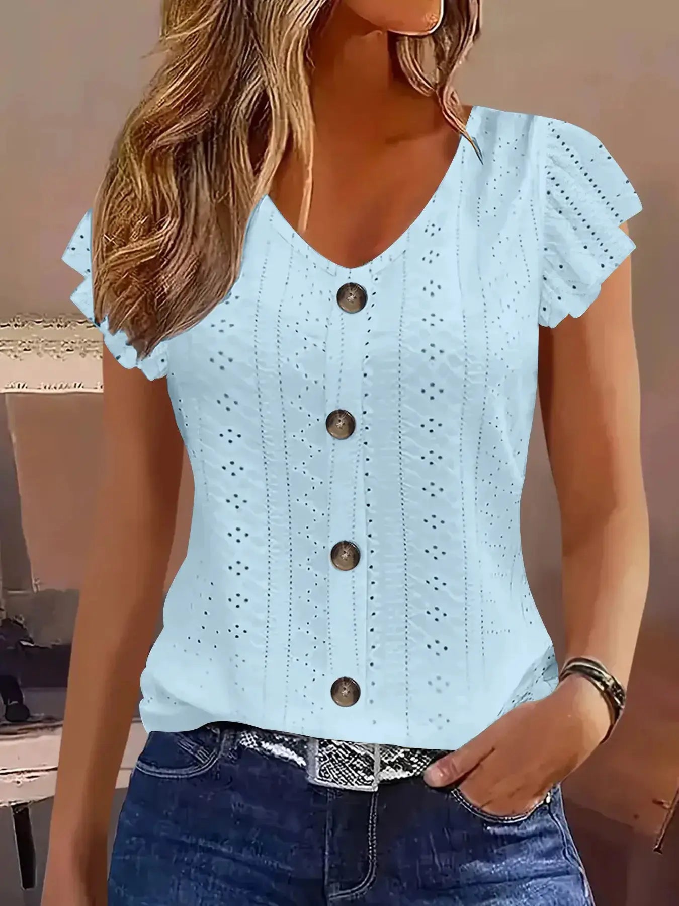 Blouse, light blue eyelet V-neck with short flutter sleeves and brown front buttons.