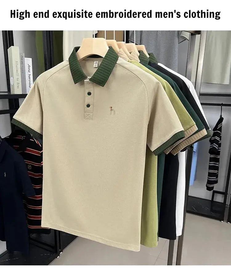 Men's polo shirt in beige with green collar and cuffs, small dog embroidery on chest; assorted colors on rack.