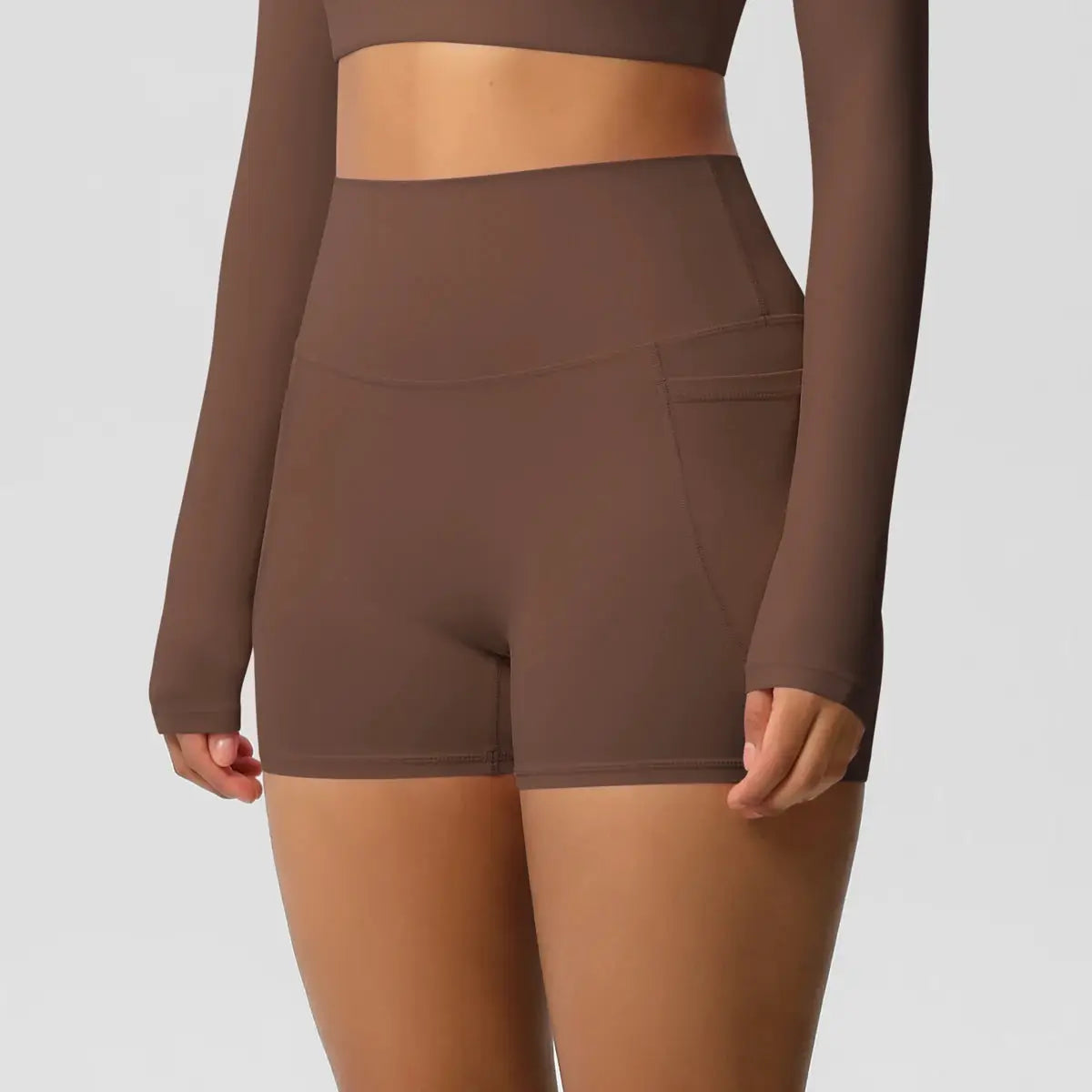 Women’s pocketed yoga shorts in brown, high-waist, quick-drying, squat-proof for workouts.