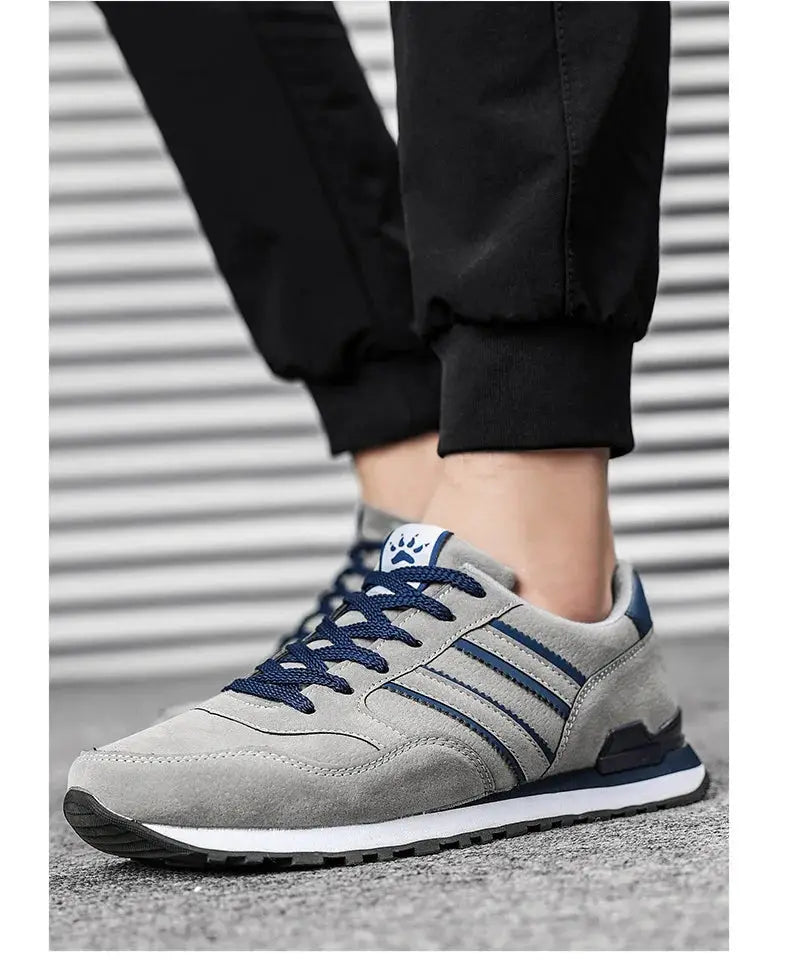 Men's gray artificial-leather sneakers with blue laces and navy stripe detail