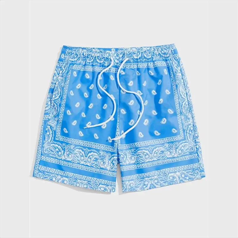Men's Trend Bandana Graphic Beach Shorts in blue with paisley bandana print and drawstring waist.