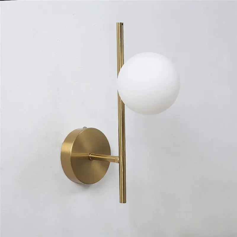 Gold LED wall lamp with vertical brass rod and milky glass globe shade