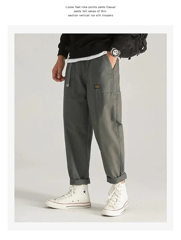 HIQOR men's cargo pants in grey, plus size, with multiple pockets, baggy fit and rolled cuffs.