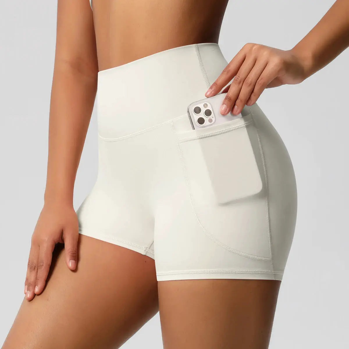 Women pocketed yoga shorts with high waist in white, side phone pocket