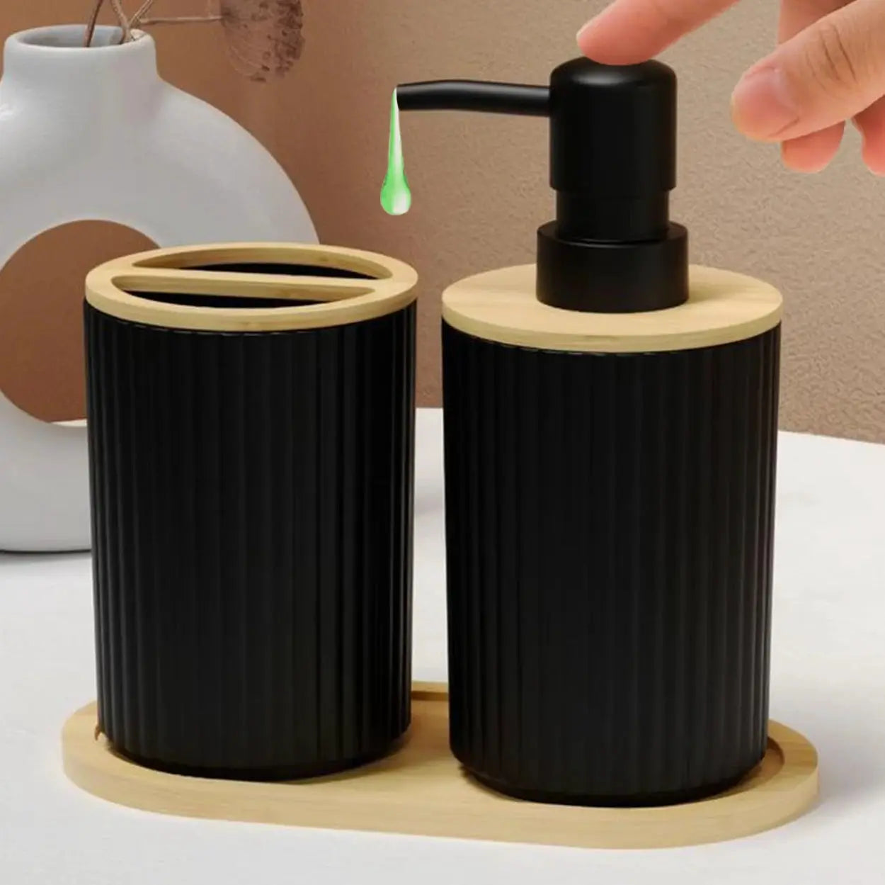 2-piece black ribbed bathroom accessories set with bamboo lids; soap dispenser and toothbrush cup on a wooden tray