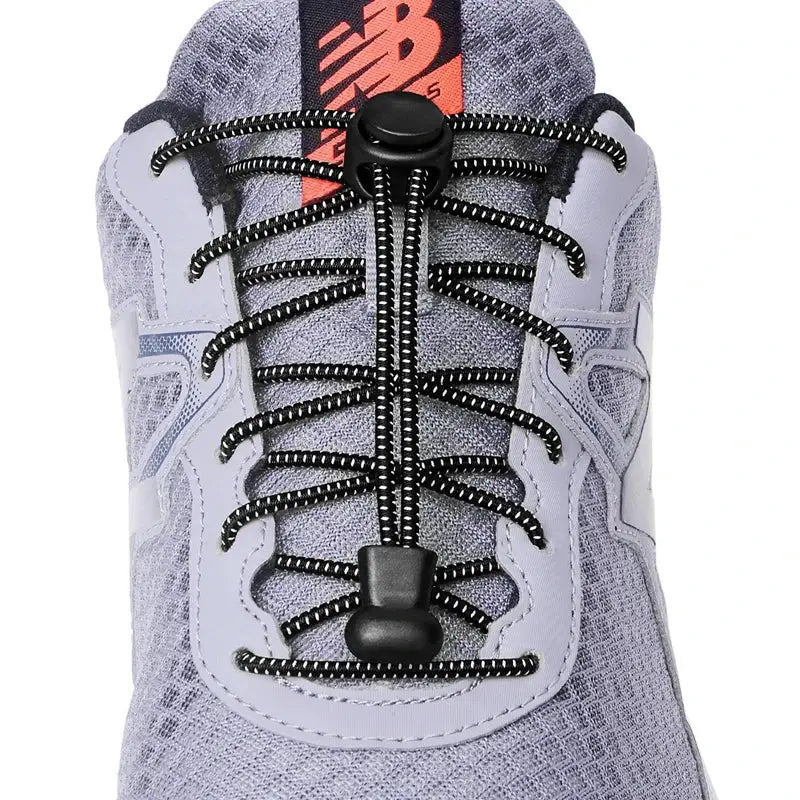 Elastic no-tie sneaker shoelaces with round black speckled cords and a cord lock; NB logo visible.