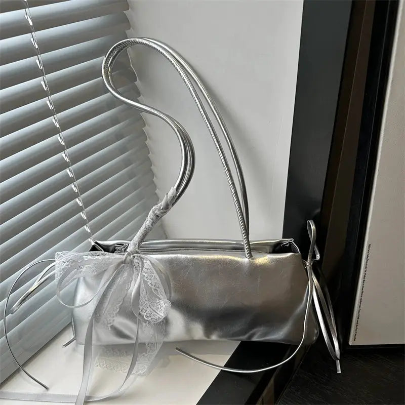 French elegant square bag in metallic silver with lace bow decoration, ballet-style shoulder bag for women