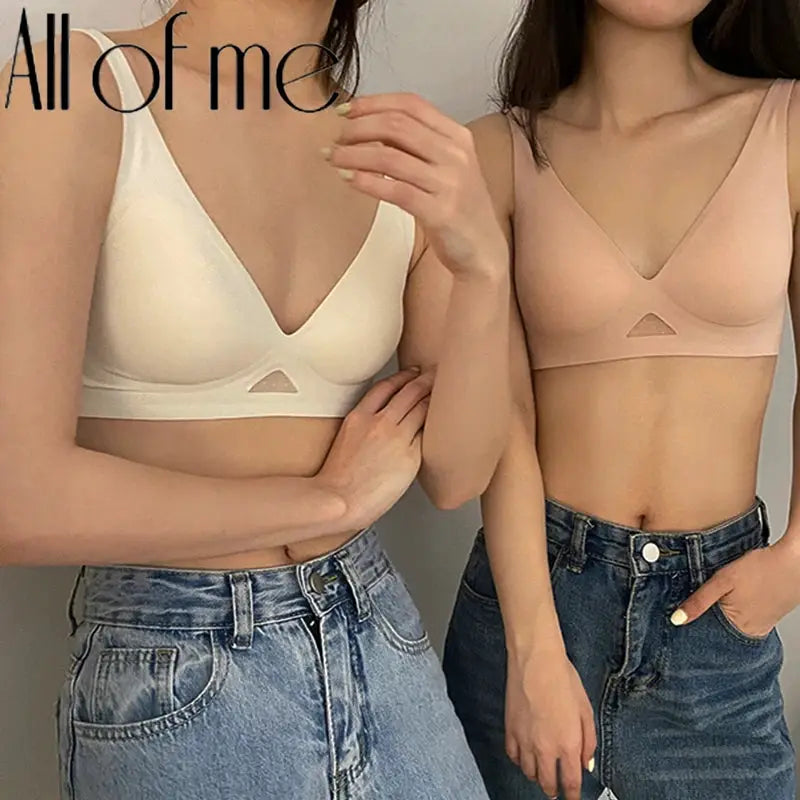 Two seamless wire-free bralettes in white and nude silky fabric with triangle cups