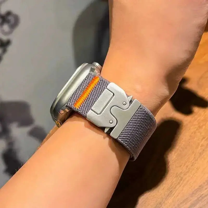 Braided elastic nylon Apple Watch strap, gray with orange stitching and metal buckle