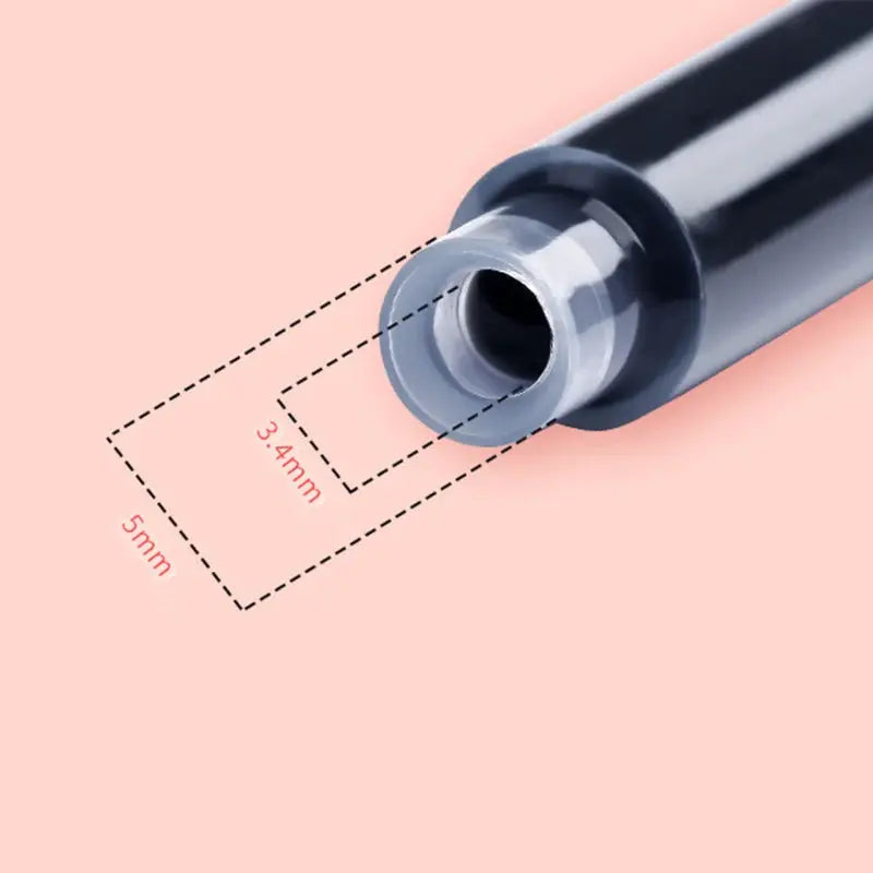 Fountain pen with black body and gray end, close-up on peach background