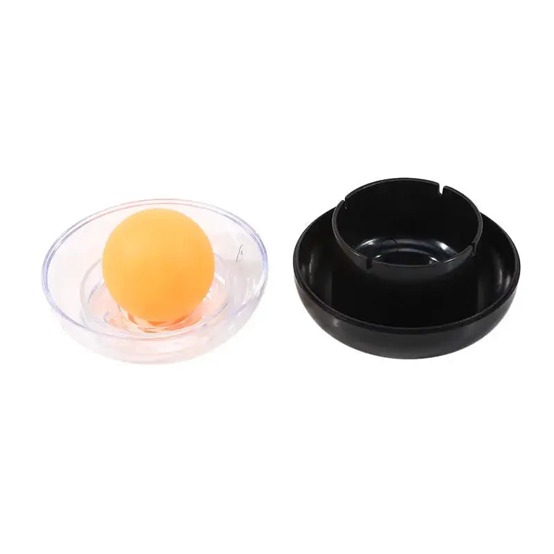 Two-piece finger wetting tool set: orange ball in a clear dish beside a black round case