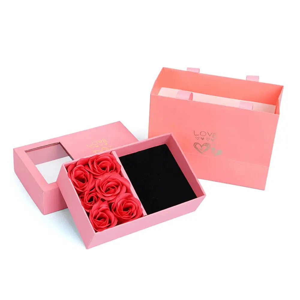 Jewelry box with pink exterior and window, immortal red roses inside, gift-ready