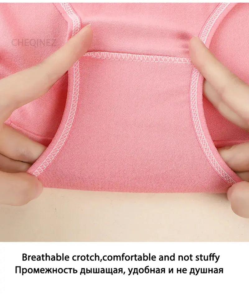 Pink cotton women's panties being stretched to reveal breathable, soft fabric.