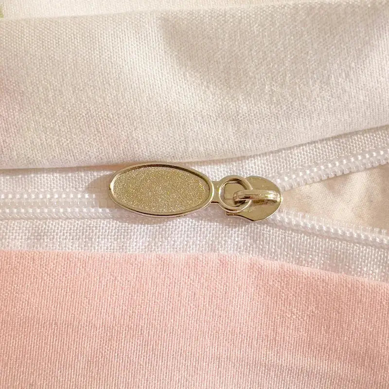 3-piece knitted and washed yarn set by Simples Market; quilt cover and two pillowcases; cream with pink accents.