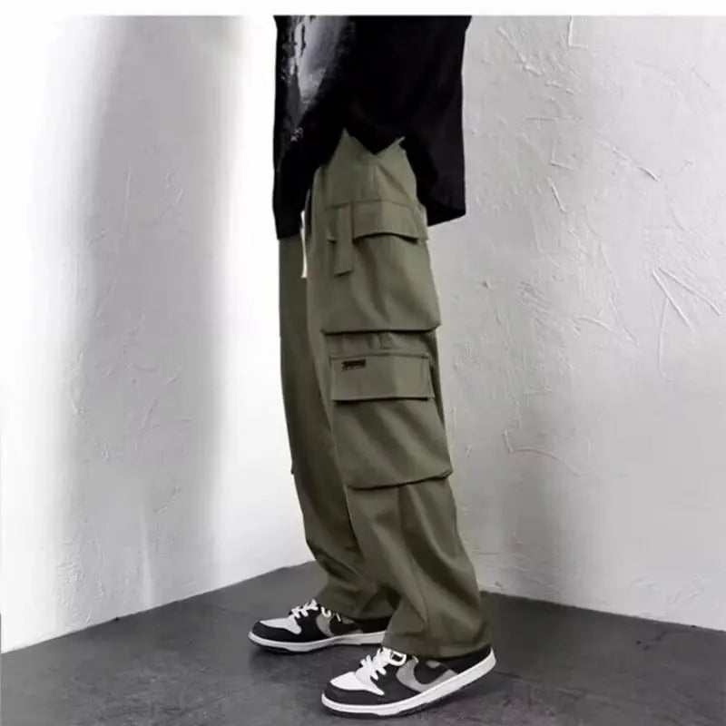 Men's olive green cargo jogger pants with oversized pockets and a baggy fit