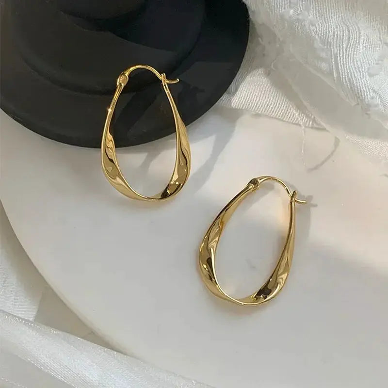 Pair of gold-tone shell-textured hoop earrings for women, daily wear accessory