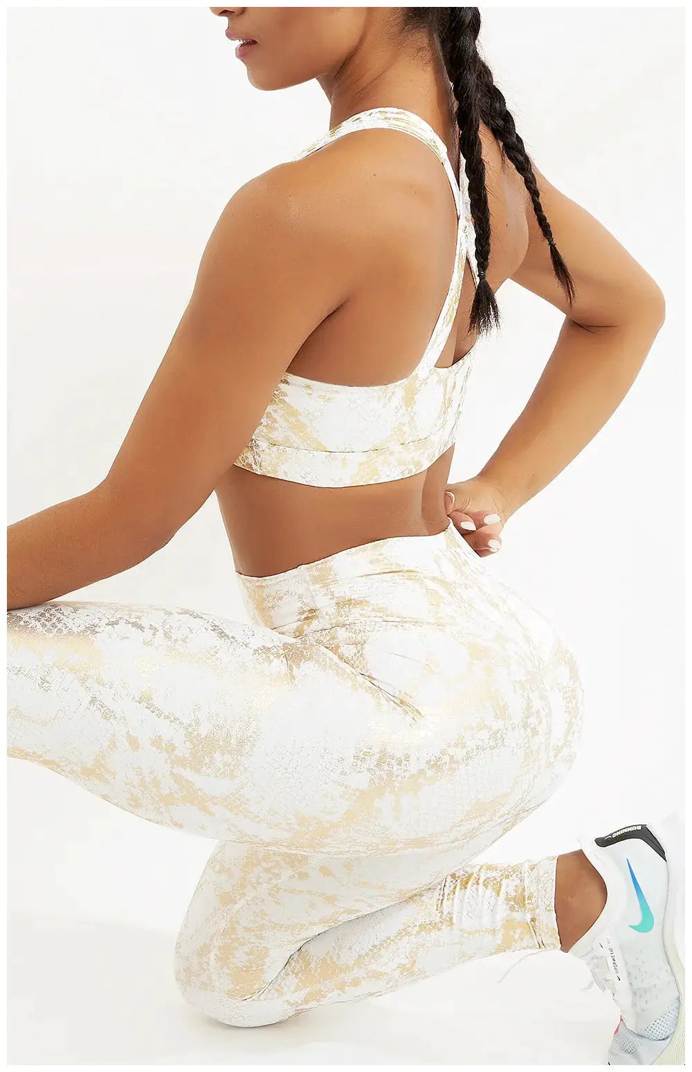 Snake-printed yoga pants and matching sports bra set in beige-gold pattern; high-waist, elastic fitness leggings