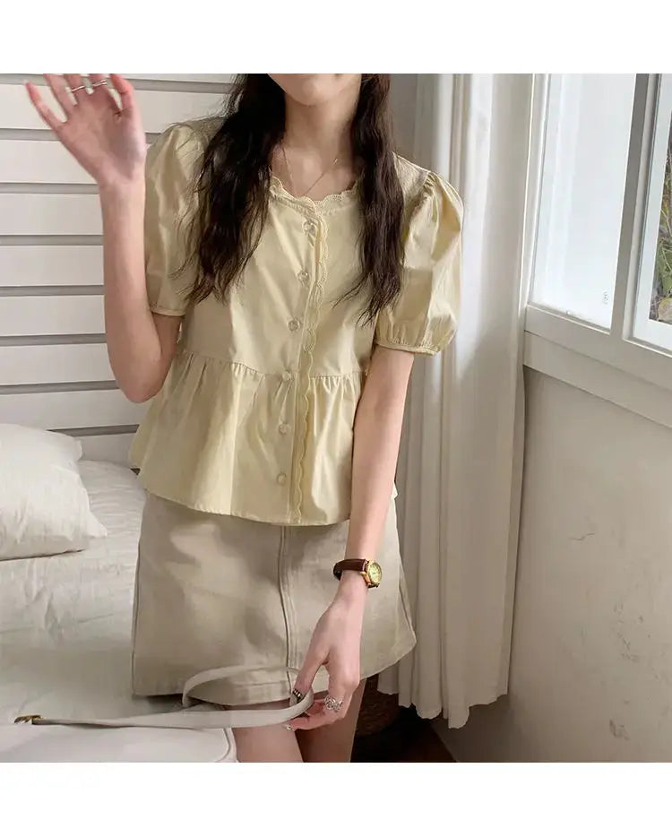 Women’s pale yellow puff-sleeve peplum blouse with button-down front