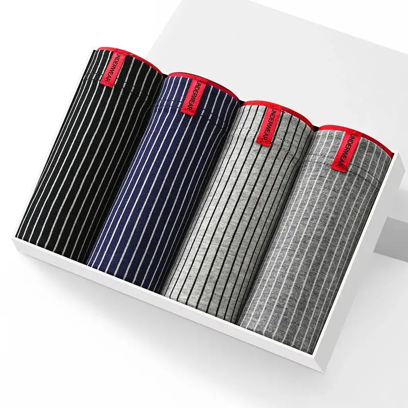 4-pack striped cotton boxer shorts for men, rolled in a white display box with red tag accents; colors black, navy, gray