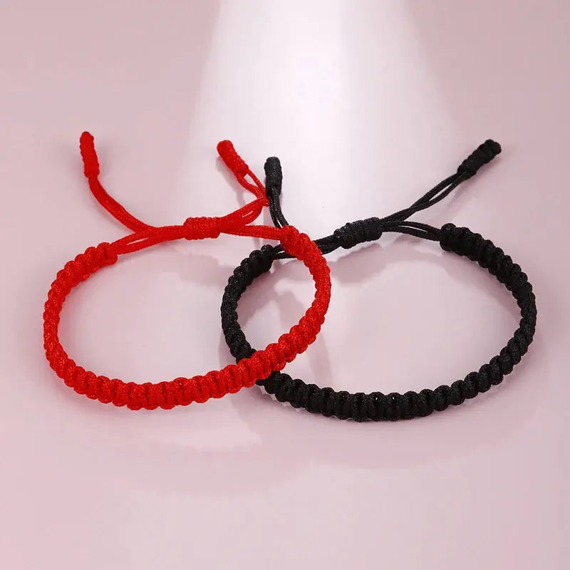 Two handmade braided string bracelets in red and black, Buddhist Tibetan woven rope good luck amulets by Simples Market