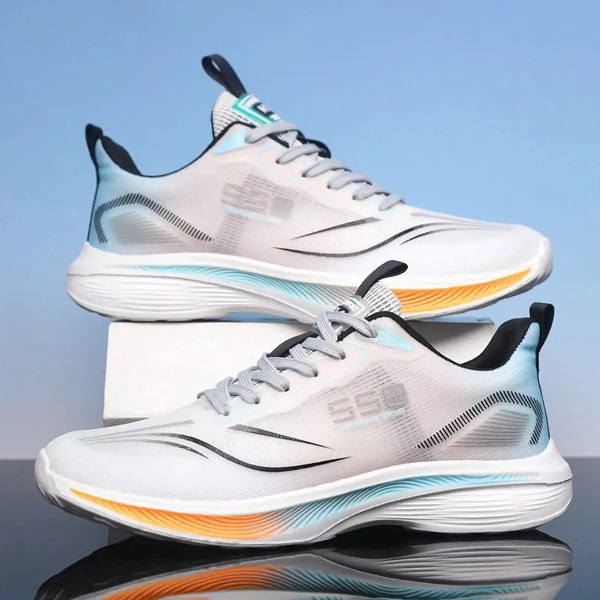 Pair of men's white running shoes with light blue accents and orange outsole