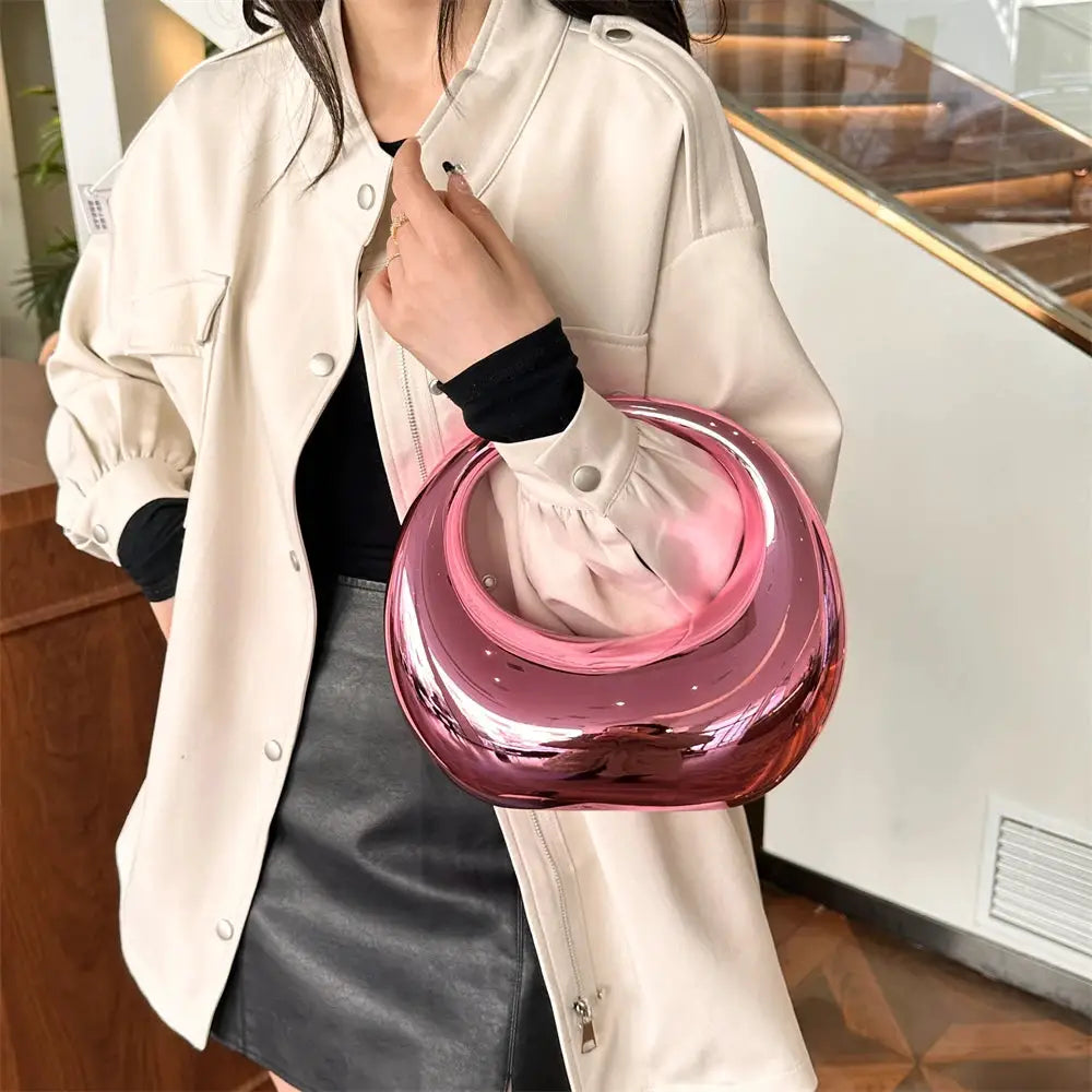 MOODS pink metallic PVC handbag with round wrist handle by Simples Market
