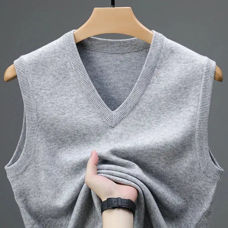 Men's grey knit sleeveless V-neck sweater vest on a wooden hanger